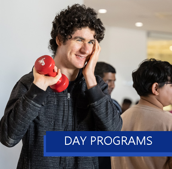Participant and Staff doing woodwork